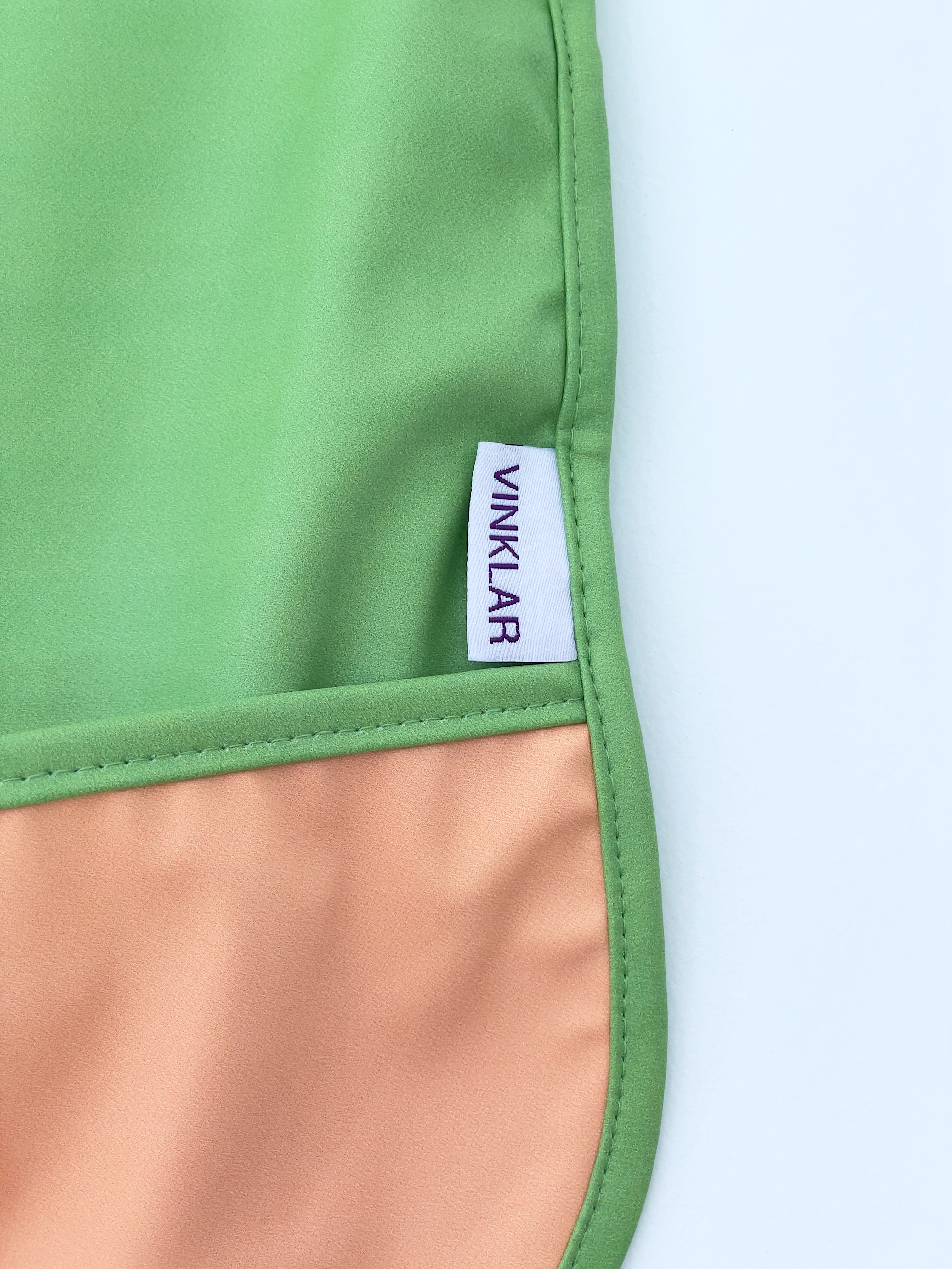 Baby's first apron for family cooking session, featuring colorful and child-friendly design, perfect for engaging young children in kitchen activities safely. Award winner company brand