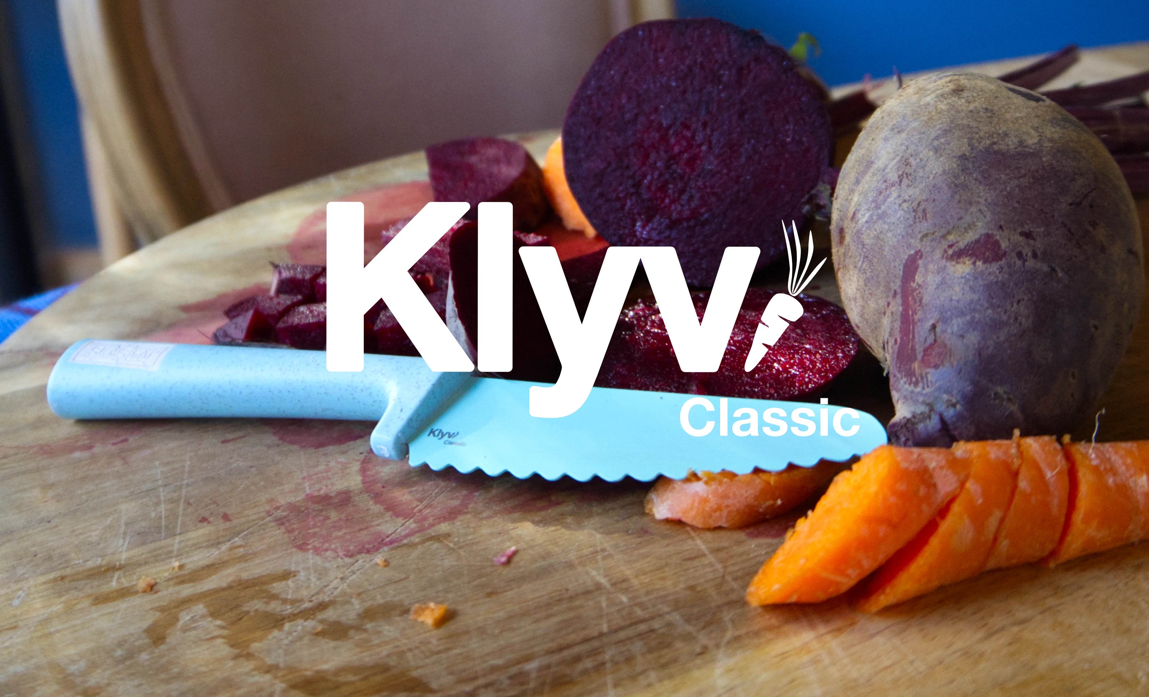 Klyv Classic safe kids knife on a cutting board with beets and carrots 3 years old