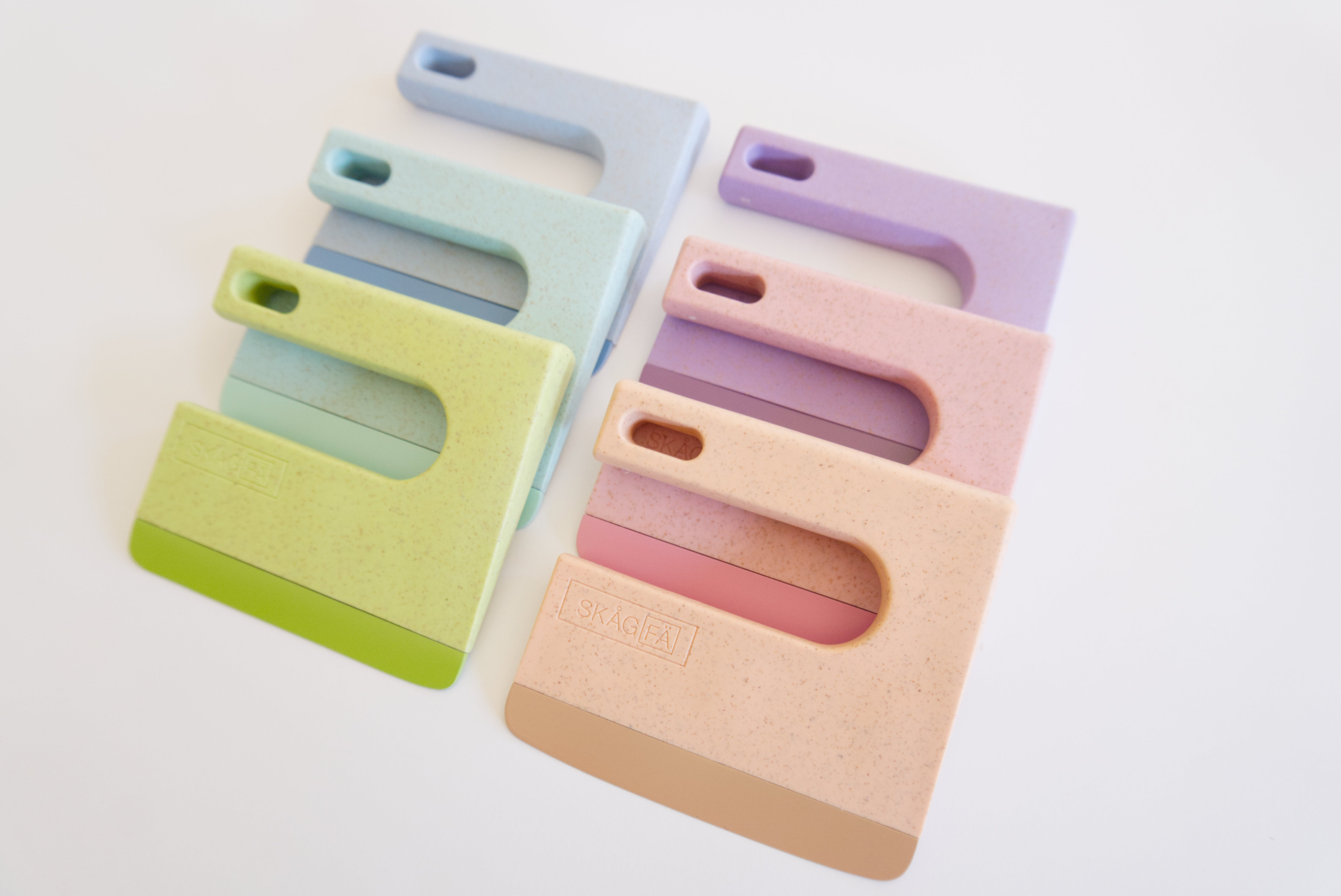 Set of colorful Klyv safe kids knife on a light background